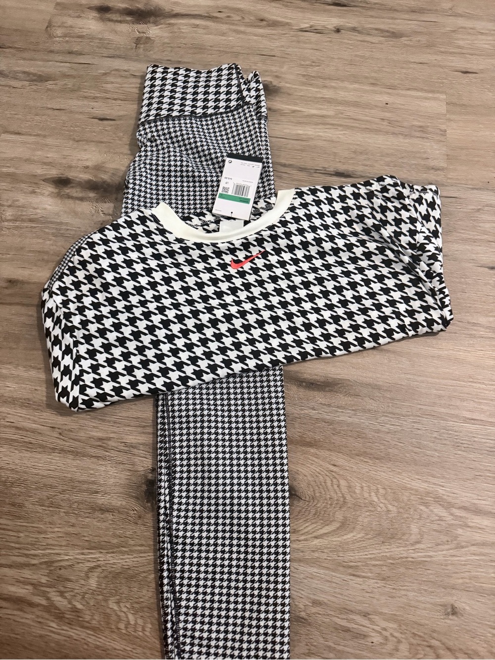 Nike women’s Black & White Houndstooth Set with orange Swoosh